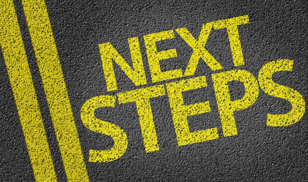 Next Steps written on the road