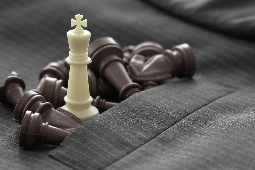 close up of chess figure on suit background strategy or leadership concept